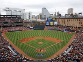 FILE - In this April 3, 2017, file photo, Baltimore Orioles starting pitcher Kevin Gausman throws to the Toronto Blue Jays in the first inning of an opening day baseball game in Baltimore. The Orioles have launched a program that will enable kids to attend home games this season free of charge. Fulfilling a child's request to "take me out to the ballpark" has become a lot cheaper at Camden Yards. Every adult who purchases a regularly-priced upper deck ticket can bring up to two children, age 9 or under.