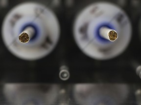 FILE - In this Thursday, Nov. 10, 2016 file photo, test cigarettes sit in a smoking machine in a lab at the Centers for Disease Control and Prevention in Atlanta. On Wednesday, March 14, 2018, the U.S. Food and Drug Administration announced a sweeping anti-smoking plan to drastically cut nicotine levels in cigarettes.