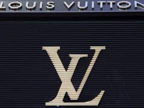 FILE - In this Sept. 20, 2017, file photo, the logo of Louis Vuitton, a fashion house and luxury retail company is pictured on their store on the Champs Elysees Avenue in Paris, France. Louis Vuitton has named Kanye West collaborator Virgil Abloh as its new men's wear artistic director.