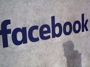 File - This Jan. 17, 2017, file photo shows a Facebook logo being displayed in a start-up companies gathering at Paris' Station F, in Paris. A former employee of a Trump-affiliated data-mining firm says it used algorithms that "took fake news to the next level" using data inappropriately obtained from Facebook.