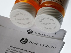 FILE - In this July 25, 2017, file photo, Express Scripts prescription medication bottles are arranged for a photo in Surfside, Fla. Health insurer Cigna will spend about $52 billion to acquire the pharmacy benefits manager Express Scripts, announced Thursday, March 8, 2018, the latest in a string of proposed buyouts and tie-ups in a rapidly shifting landscape for the health services industry.