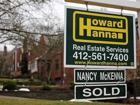 FILE- This Jan. 22, 2018, file photo shows a sold sign in front of a home in Mount Lebanon, Pa. On Tuesday, March 27, the Standard & Poor's/Case-Shiller 20-city home price index for January is released.