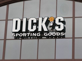 FILE- In this March 1, 2018, file photo, a sign for Dick's Sporting Goods store is displayed at the store in Madison, Miss. Dick's Sporting Goods, Inc. reports earnings Tuesday, March 13, 2018.
