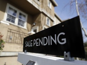 FILE- In this March 6, 2018, photo a sign advertises the pending sale of a home in San Jose, Calif. On Wednesday, March 28, the National Association of Realtors releases its February report on pending home sales.