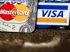 In this Wednesday, Jan. 31, 2018, photo, Master Card and Visa logos on credit cards is shown in Zelienople, Pa. On Wednesday, March 7, the Federal Reserve releases its January report on consumer borrowing.