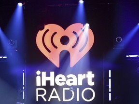 FILE- In this Nov. 7, 2017, file photo, the logo for iHeartRadio, owned by iHeartMedia, Inc., is shown during an album release party with Maroon 5 in Burbank, Calif. IHeartMedia, one of the world's largest radio and billboard companies, has filed for Chapter 11 bankruptcy protection. The San Antonio-based iHeartMedia Inc., which was formerly Clear Channel Communications, said Thursday, March 15, 2018, that it has reached an agreement with the holders of more than $10 billion of its debt and will restructure its finances as a result.