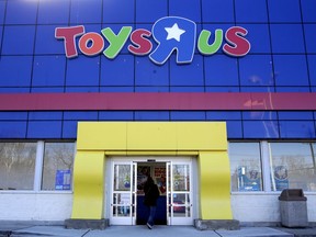 FILE- In this Jan. 24, 2018, file photo, a woman enters a Toys R Us store in Paramus, N.J. Toys R Us CEO David Brandon told employees Wednesday, March 14, 2018, that the company's plan is to liquidate all of its U.S. stores, according to an audio recording of the meeting obtained by The Associated Press.