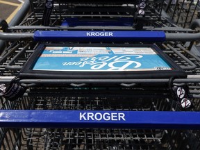 This June 15, 2017, photo, shows Kroger grocery store shopping carts with the store's name in Flowood, Miss. Kroger reports financial results on Wednesday, March 7, 2018.