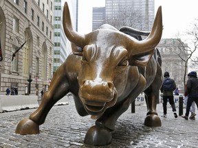 FILE- This Feb. 7, 2018, file photo shows the Charging Bull sculpture by Arturo Di Modica, in New York's Financial District. The stock market's near decade-long climb upward since the depths of the Great Recession turns nine years old Friday, March 9, the second longest U.S. bull market since World War II.
