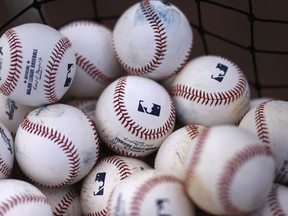 FILE- In this Feb. 22, 2015, file photo, a basket of baseballs sits on a practice field as Pittsburgh Pirates catchers take batting practice during a baseball spring training workout in Bradenton, Fla. Facebook is getting deeper into the professional sports streaming game, signing a deal with Major League Baseball to show 25 afternoon games in an exclusive deal. The games will be available Facebook users in the U.S. on Facebook Watch, the company's video feature, via the MLB Live show page Facebook said Friday, March 9, 2018.