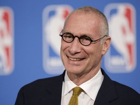 FILE - In this Oct. 6, 2014, file photo, ESPN President John Skipper smiles during a news conference in New York. The former president of ESPN says he resigned from the sports network after an extortion plot by his cocaine dealer. John Skipper told the Hollywood Reporter on Thursday, March 15, 2018, "they threatened me." Skipper says he understood the threat put himself, his family and his professional life at risk.