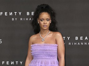 FILE - In this Sept. 19, 2017 file photo, singer Rihanna poses for photographers at the Fenty Beauty by Rihanna fashion range launch during London Fashion Week. An ad on Snapchat asking users if they'd rather "Slap Rihanna" or "Punch Chris Brown" has spawned widespread outrage, including from the singer herself. Rihanna, who Brown was convicted of assaulting when she was his girlfriend in 2009, posted a statement on her Snapchat and Instagram accounts saying the ad intentionally brings shame to domestic violence victims.