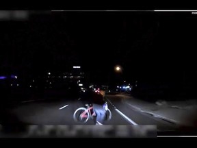 This image made from video Sunday, March 18, 2018, of a mounted camera provided by the Tempe Police Department shows an exterior view moments before an Uber SUV hit a woman in Tempe, Ariz. Video of a deadly self-driving vehicle crash in suburban Phoenix shows the pedestrian walking from a darkened area onto a street just moments before the crash. (Tempe Police Department via AP)