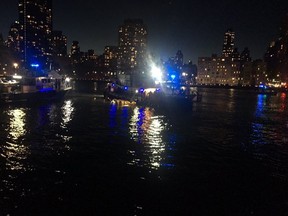 This image made from video provided by the New York City Police Department shows the scene of a helicopter crash in the East River in New York on Sunday, March 11, 2018. A Federal Aviation Administration spokeswoman said Sunday the Eurocopter AS350 went down just after 7 p.m. Sunday in the waterway just north of Roosevelt Island and is "reportedly inverted in the water." (New York City Police Department via AP)