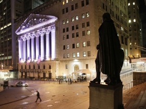 FILE - In this Wednesday, Oct. 8, 2014, file photo, a statue of George Washington stands near the New York Stock Exchange, in background. The U.S. stock market opens at 9:30 a.m. EDT on Tuesday, March 20, 2018.