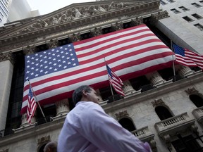 FILE - In this Aug. 8, 2011 file photo, a pedestrian walks past the New York Stock Exchange in New York. The U.S. stock market opens at 9:30 a.m. EDT on Thursday, March 22, 2018.