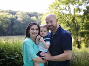 This undated photo shows Amber and Elliott Ash holding son, Ethan. The Ash's have filed a class action lawsuit against University Hospitals in Cleveland after its fertility clinic in suburban Cleveland discovered a storage tank malfunction March 4 and said last week that as many as 2,000 frozen eggs and embryos may have been damaged. (Ash family photo via AP)