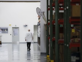 In this Oct. 24, 2017, photo, an employee walks off the manufacturing floor while wearing his laboratory coat at Lord Corporation, a manufacturer of industrial coatings, adhesives, bearings, and sensing equipment for range of commercial markets, including United States military contracts in Erie, Pa. Since 2008, Erie has suffered a hidden and potentially more devastating exodus: The loss of well-paid white-collar jobs. The city has shed 8 percent of its accountants, 10 percent of its computer workers, 40 percent of its engineers and 20 percent of its lawyers, according to government occupational data analyzed by The Associated Press.