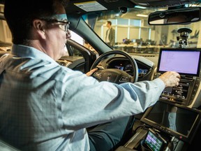 Grant Courville, VP of product management, shows one of the automated vehicles in the BlackBerry QNX Autonomous Vehicle Innovation Centre in Ottawa.