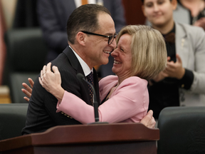 Alberta Finance Minister Joe Ceci hugs Premier Rachel Notley after delivering Budget 2018 in the Alberta Legislature.