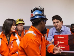 Prime Minister Justin Trudeau speaks with workers during a visit to Stelco Hamilton Works in Hamilton Ont., Tuesday, March 13, 2018.