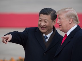 China's President Xi Jinping and US President Donald Trump attend a welcome ceremony at the Great Hall of the People in Beijing on November 8, 2017