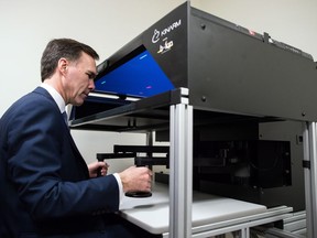 Finance Minister Bill Morneau practices a KINARM test used to test motor skills and brain functions after a stroke, during a tour of the Brain Behaviour Laboratory at the University of British Columbia in Vancouver, B.C., on Tuesday March 6, 2018.