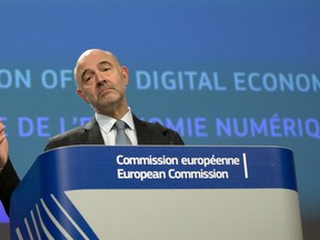 European Commissioner for Economic and Financial Affairs Pierre Moscovici speaks during a media conference at EU headquarters in Brussels, Wednesday, March 21, 2018.