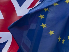 FILE - In this Friday, Dec. 8, 2017 file photo, the British and EU flags flap in the wind outside EU headquarters in Brussels. European Council President Donald Tusk unveiled on Wednesday, March 7, 2018, the EU's approach to the next phase of Brexit talks on future relations with the UK.