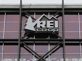 A sign at the REI flagship store is shown Friday, March 2, 2018, in Seattle. The outdoor retailer says it's halting future orders of some popular brands, including CamelBak water carriers, Giro helmets and Camp Chef stoves, whose parent company also makes ammunition and assault-style rifles.  The Seattle-based company has been facing mounting pressure from some customers.