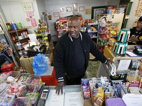 FILE - In this Feb. 26, 2018, file photo, Carl Lewis in his market in Rankin, Pa. About half of Lewis' customers pay with benefits from the federal Supplemental Nutrition Assistance Program, so the government's proposal to replace the debit card-type program with a pre-assembled box of shelf-stable goods delivered to recipients worries him and other grocery operators in poor areas. Food stamp administrators across the country are expressing reservations about "America's Harvest Box," pitched by Agriculture Department officials as a way to cut costs and improve efficiency. The government is proposing to replace the debit card-type program with a pre-assembled box of shelf-stable goods delivered to recipients.