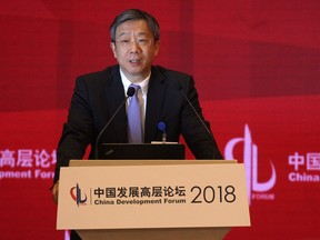China's Central Bank Governor Yi Gang speaks at the China Development Forum at the Diaoyutai State Guesthouse in Beijing, Sunday, March 25, 2018. Yi outlined sweeping plans Sunday to rein in rising debt and financial risk, but expressed confidence that Beijing can prevent potential dangers.