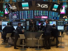 Traders work on the floor at the closing bell of the Dow Industrial Average at the New York Stock Exchange on January 2, 2018 in New York.  Wall Street opened 2018 on a winning note Tuesday, bidding Nasdaq to its first-ever close above 7,000 points following a rally in technology shares. At the closing bell, the tech-rich Nasdaq Composite Index had jumped 1.5 percent to end the first session of the year at 7,006.90. The S&P 500 also notched a fresh record, gaining 0.8 percent to close at 2,695.79, while the Dow Jones Industrial Average rose 0.4 percent to 24,824.01, about 13 points below its all-time record.  / AFP PHOTO / Bryan R. SmithBRYAN R. SMITH/AFP/Getty Images