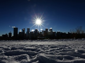 Steam and exhaust rise from buildings in the downtown Calgary skyline. Interest rate hikes will affect families in Alberta more than in provinces with notoriously overpriced housing markets, an RBC report says.