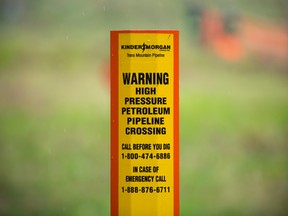 A petroleum pipeline crossing marker stands near the Kinder Morgan facility in Burnaby, British Columbia.
