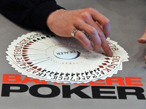 A dealer gives cards to players during the PokerStars European Poker Tour (EPT) held at the Barriere Casino in Deauville, western France.