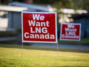 Signs reading "We Want LNG Canada" stand on a lawn in the residential area of Kitimat, British Columbia.