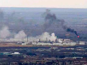 This image from video provided by WDIO-TV in Duluth shows smoke rising from the Husky Energy oil refinery after an explosion Thursday morning, April 26, 2018 in Superior, Wis. Authorities say several people were injured in the explosion.