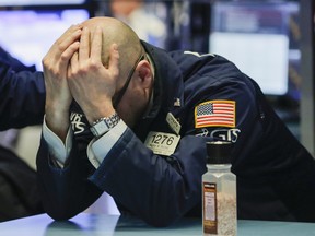 A trader on the floor of the New York Stock Exchange after markets plunged in March.