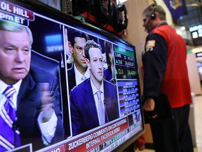 A television on the floor of the New York Stock Exchange displays a live feed of Mark Zuckerberg as he testifies before Congress on April 10.