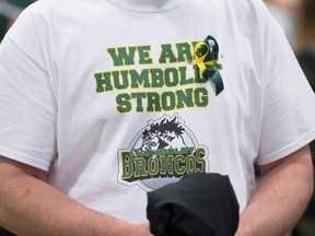 A man wears a Humboldt Broncos shirt during a vigil at the Elgar Petersen Arena, home of the Humboldt Broncos, to honour the victims of a fatal bus accident, April 8, 2018 in Humboldt, Canada.