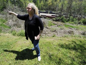 In this April 12, 2018 photo, Mayor Heather Hall discusses the nearby train that was loaded with tons of sewage sludge that is stinking up her community of Parrish, Ala. More than two months after the so-called "Poop Train" rolled in from New York City, Hall says her small town smells like rotting corpses. Some say the trainloads of New Yorkers' excrement is turning Alabama into a dumping ground for other states' waste.