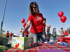 Teacher Jennifer Galluzzo casts her ballot outside Paseo Verde Elementary Wednesday, April 18, 2018 in Peoria, Ariz. Arizona teachers are weighing whether to walk out of their classrooms to demand more school funding after weeks of growing protests, a vote that's raising questions about how an unprecedented strike could play out across the state's education system.