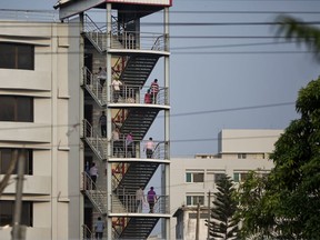 In this April 18, 2018 photo,  Bangladeshi garment workers walk down the stairs of a garment factory building at the end of the day's work in Savar, Bangladesh. A new survey says that five years after the Rana Plaza garment factory building collapse in Bangladesh killed 1,134 people and left thousands injured some things have changed for the better for the workers who toiled in the country's huge garment industry but much remains to be done. The survey by the Center for Business and Human Rights at New York University's Stern School of Business found that the largest factories generally have complied with new safety standards set by foreign clothing brands since the 2013 accident.