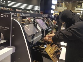 In this Thursday, April 19, 2018 photo, Najla Sultan bin Awwad works at Sephora in Riyadh. The mother of two in her 30s started working for the first time a year ago at the store, says even women who cover their face with a veil are becoming bolder in public, wearing colored contact lenses, eyelashes and drawing their eyeliner they way they want.