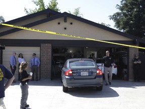 A car is backed out of the garage of a home searched in connection with the arrest of a man on suspicion of murder, Wednesday, April 25, 2018, in Citrus Heights, Calif. The Sacramento County District Attorney's Office plans to make a major announcement in the case of a serial killer they say committed at least 12 homicides, 45 rapes and dozens of burglaries across California in the 1970's and 1980s.