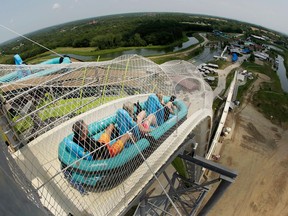 FILE - In this July 9, 2014, file photo, riders go down the water slide called "Verruckt" at Schlitterbahn Waterpark in Kansas City, Kan. Late Monday, April 2, 2018, federal authorities in Dallas arrested John Timothy Schooley, one of the designers of the water slide that decapitated a 10-year-old boy in 2016. Schooley and Jeffrey Henry, a co-owner of Texas-based Schlitterbahn Waterparks and Resorts, were indicted last week by a grand jury in Kansas. Schooley will be held in Dallas pending his arraignment and extradition to Kansas on charges that include second-degree murder.