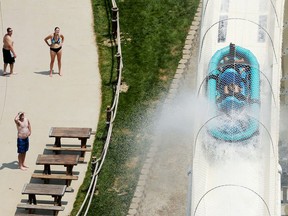 FILE - In this July 9, 2014 file photo, riders are propelled by jets of water as they go over a hump while riding a water slide called "Verruckt" at Schlitterbahn Water Park in Kansas City, Kan. A lender on Monday, April 9, 2018, warned investors that criminal indictments stemming from the decapitation of a 10-year-old boy on the slide in 2016 at the park could hurt owner Schlitterbahn's chances of repaying a $174.3 million loan balance.