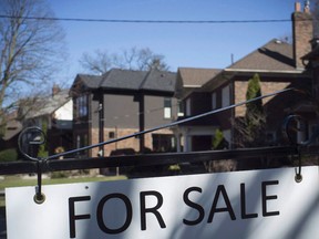 A sold sign is shown in front of west-end Toronto homes Sunday, April 9, 2017. The Toronto Real Estate Board says home sales in the Greater Toronto Area in March fell 39.5 per cent compared with a year ago.