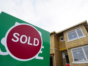 "For Sale" and "Sold" signs are shown outside a new home in Beckwith, Ont., on Wednesday, Jan. 11, 2018. Canada Mortgage and Housing Corp. says the annual pace of housing starts in March slowed compared with February.